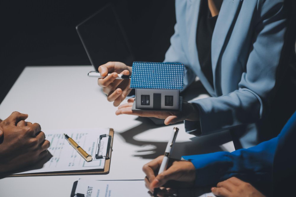 Property adviser holding a model home